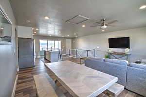 Dining space featuring dark wood finished floors, attic access, and recessed lighting