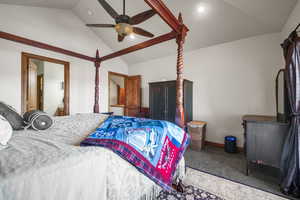 Carpeted bedroom featuring baseboards, a ceiling fan, and vaulted ceiling