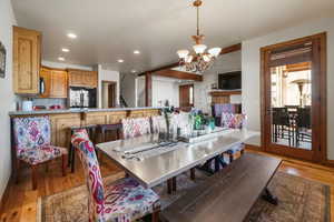 Dining space featuring a chandelier, wood finished floors, and recessed lighting