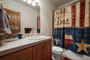 Full bathroom with visible vents, toilet, tile patterned flooring, and vanity