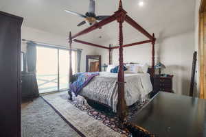 Bedroom with a ceiling fan, access to outside, carpet, and lofted ceiling