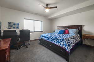 Bedroom featuring carpet floors, baseboards, ceiling fan, and visible vents