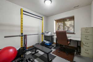 Office area featuring baseboards and visible vents