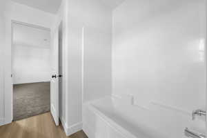 Bathroom with baseboards and wood finished floors