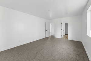 Unfurnished room with baseboards and carpet