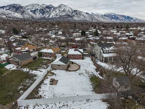Snowy aerial view featuring a residential view and a mountain view