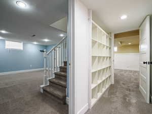 Stairway with recessed lighting, baseboards, and carpet flooring