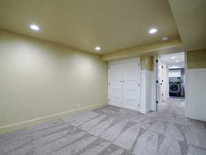 Unfurnished bedroom with washer / clothes dryer, recessed lighting, a closet, carpet floors, and baseboards