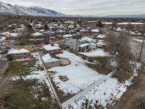 Snowy aerial view with a mountain view and a residential view