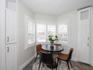 Dining room featuring stone finish flooring and baseboards
