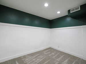 Carpeted spare room with recessed lighting and visible vents