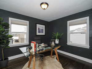 Office space with plenty of natural light, baseboards, and wood finished floors
