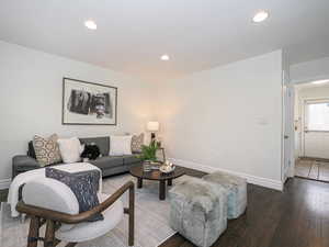Living room featuring recessed lighting, baseboards, and wood-type flooring