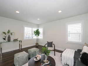 Living area featuring recessed lighting, baseboards, and wood finished floors