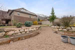 Exterior space with a gate, a mountain view, and fence