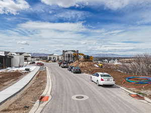 View of street featuring curbs, a mountain view, and sidewalks