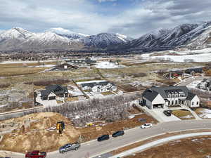 Snowy aerial view with a mountain view and a residential view