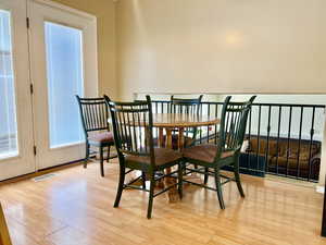 Dining space with visible vents, baseboards, and light wood finished floors