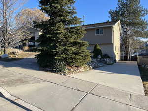 View of property exterior featuring brick siding and driveway