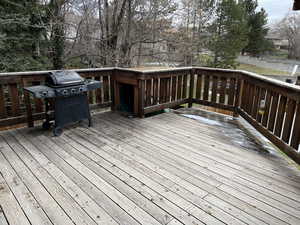 Wooden deck featuring area for grilling