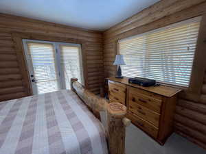 Carpeted bedroom featuring access to outside