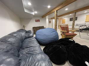 Interior space featuring recessed lighting, beam ceiling, and carpet floors
