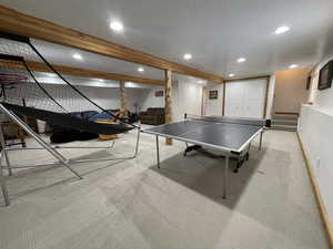 Rec room featuring baseboards, beamed ceiling, carpet flooring, recessed lighting, and a textured ceiling