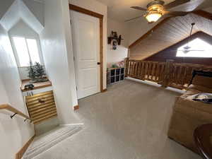 Bonus room featuring lofted ceiling, a textured ceiling, ceiling fan, and carpet flooring