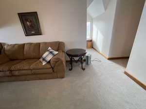 Carpeted living area featuring baseboards