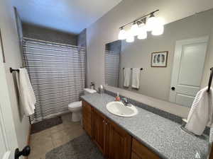 Full bath featuring vanity, toilet, and a shower with curtain