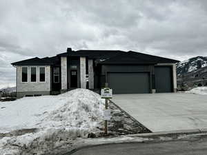 Prairie-style home featuring a garage and driveway