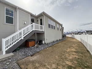 View of home's exterior with stairs and fence