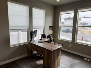 Office space featuring visible vents, baseboards, and dark wood-style flooring