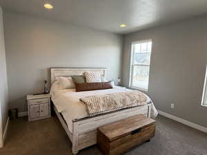 Bedroom featuring recessed lighting, baseboards, and dark carpet