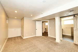 Basement with visible vents, a textured ceiling, recessed lighting, carpet floors, and baseboards