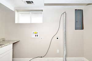 Laundry room with visible vents, washer hookup, electric panel, cabinet space, and hookup for an electric dryer