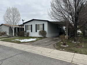 Manufactured / mobile home with a carport and driveway