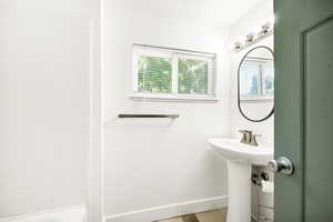Bathroom with plenty of natural light, baseboards, and tile patterned flooring