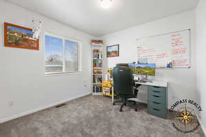 Bedroom 2 being used as Office with carpet flooring, baseboards, and visible vents