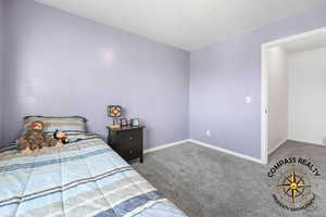 bedroom 4 featuring baseboards and carpet