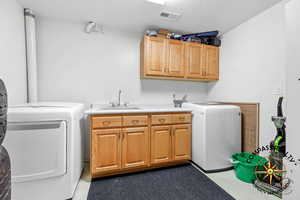 2nd Laundry room area with visible vents, a sink, washer and dryer, a textured ceiling, and cabinet space