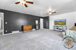bedroom 3 or Bonus Room over garage featuring visible vents, baseboards, a textured ceiling, and a ceiling fan or can be used a a bonus room over garage