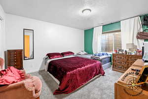 Bedroom 6 featuring carpet flooring and a textured ceiling