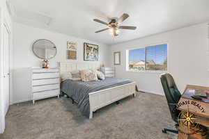 Primary Bedroom Carpeted bedroom with attic access, baseboards, and ceiling fan