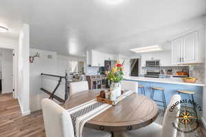 Dining area featuring baseboards and wood finished floors