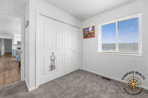 bedroom 2 with a closet, visible vents, carpet flooring, and baseboards