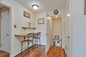 Hallway featuring wood finished floors