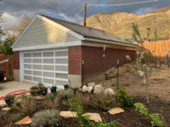 View of property exterior featuring fence, an outbuilding, and a mountain view