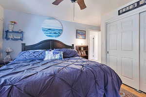 Bedroom #1 with wood finished floors, ceiling fan, and a closet