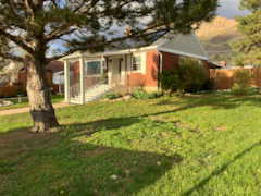 View of front of house with a front lawn and fence